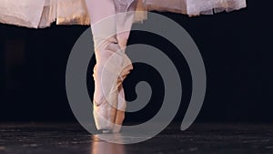 Close-up of the unrecognised ballerina standing on pointe shoes. HD.