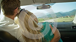 CLOSE UP: Unrecognizable couple drives through the idyllic countryside in summer