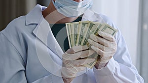 Close-up unrecognizable doctor nurse medical worker surgeon practitioner in white coat protective face mask and latex
