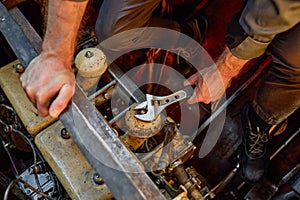 Close up unrecognizable worker repairing engine