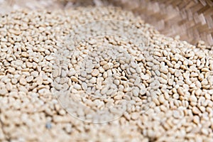 Close up of unroasted coffee beans in basket