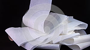 Close up of an unrolling of toilet paper with the empty card at the side