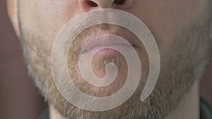 Close up of unshaven man eating an Apple