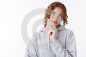 Close-up unsure cute redhead teenage girl thinking look up dreamy thoughtfully touching chin deciding what wear college