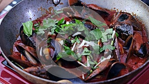 Close up up real time view in deep frying pan cooking sea mussels