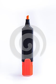 Close-up up of a single orange felt tip marker pen on white background. Standing shot of a Thick Sketch Pen or Highlighter.