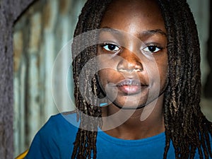 Close up upset thoughtful African boy sitting alone, looking in distance, thinking about teen problem, first love or trouble at