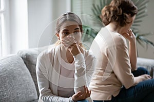 Close up upset young woman and mature mother after quarrel