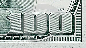 Close up on US dollar banknotes. Number 100 on US Dollar banknotes. Shooting by 1:1 Macro lense. I