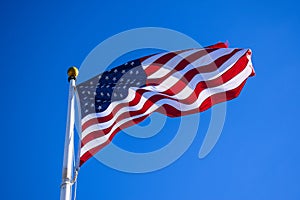 Close-up USA Flag Waving on a High Quality Clear Blue Sky