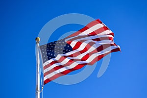 Close-up USA Flag Waving on a High Quality Clear Blue Sky