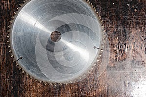 Close-up used blade circular saw on the background of the wooden table Verscak. Workshop for the production of wooden