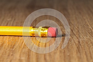 Close up of a used single yellow pencil eraser