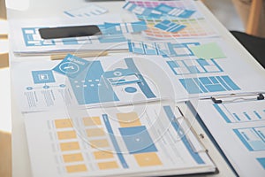 Close up ux developer and ui designer use augmented reality brainstorming about mobile app interface wireframe design on desk at