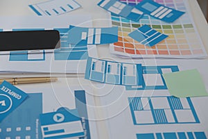 Close up ux developer and ui designer use augmented reality brainstorming about mobile app interface wireframe design on desk at