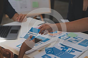 Close up ux developer and ui designer use augmented reality brainstorming about mobile app interface wireframe design on desk at