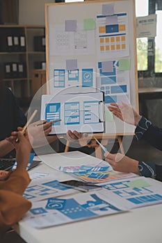 Close up ux developer and ui designer use augmented reality brainstorming about mobile app interface wireframe design on desk at