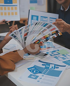 Close up ux developer and ui designer use augmented reality brainstorming about mobile app interface wireframe design on desk at