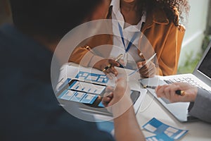 Close up ux developer and ui designer use augmented reality brainstorming about mobile app interface wireframe design on desk at