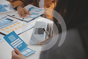 Close up ux developer and ui designer use augmented reality brainstorming about mobile app interface wireframe design on desk at