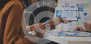 Close up ux developer and ui designer use augmented reality brainstorming about mobile app interface wireframe design on desk at