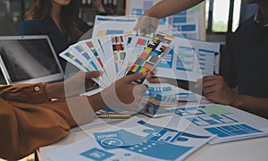 Close up ux developer and ui designer use augmented reality brainstorming about mobile app interface wireframe design on desk at