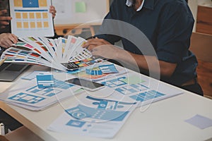 Close up ux developer and ui designer use augmented reality brainstorming about mobile app interface wireframe design on desk at