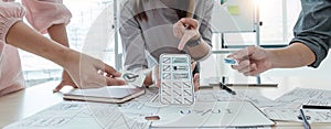 A close-up of an ux ui developer and an ui designer working on a mockup icon interface for a mobile app
