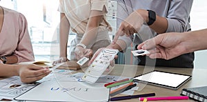 A close-up of an ux ui developer and an ui designer working on a mockup icon interface for a mobile app