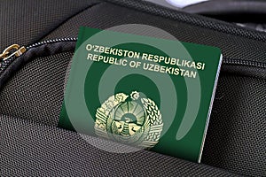 Close up of Uzbekistan Passport in Black Suitcase Pocket