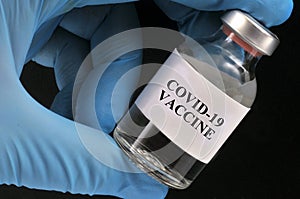 Covid-19 vaccine vial concept on black background
