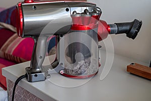 Close up vacuum cleaner with full of dusts. Extreme home cleaning