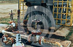 Close-Up Of Valve On Pipeline. Oil Or Gas Transportation With Gas Or Pipe Line Valves On Soil And Sunrise Background