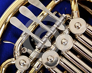 Close up of the valves and keys of a french horn