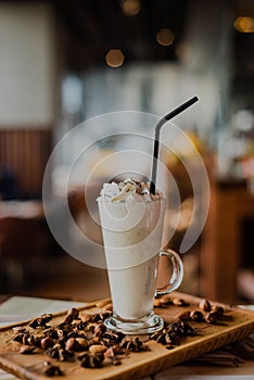 Close-up of a Vanilla milkshake with whipped cream in a tall glass with whipped cream
