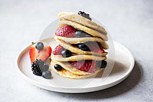 Close up of vanilla pancakes with fruits and berries