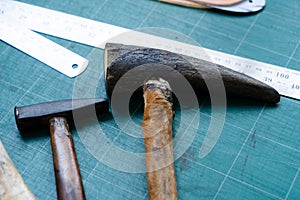 Close-up variety tools available trim leather for craft work, made by myself with all these hands equipment, there both brushes