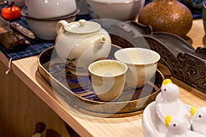Close-up of various Chinese tea sets on shelves