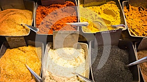 Close Up of Various kinds of colorful Spices and Curry in bowls at Market