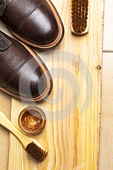 Close Up of Various Shoes Cleaning Accessories for Dark Brown Grain Brogue Derby Boots Made of Calf Leather with Special Tools
