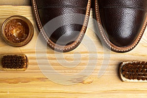 Close Up of Various Shoes Cleaning Accessories for Dark Brown Grain Brogue Derby Boots Made of Calf Leather with Special Tools