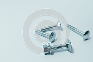Close-up of various steel nuts and bolts. Mechanical, constructional still life. Nut and bolts on white background