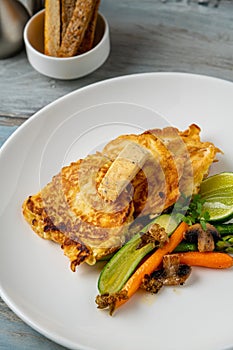 Close-up of vegetable omelette served with asparagus and carrots