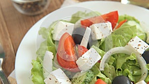 Close up of vegetable salad bowl and fork at home