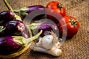 Close up of vegetables for a spicy Indian lunch i.e. Egg plant,Solanum melongena,Tomato,Solanum lycopersicum and spring onions,