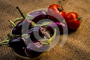 Close up of vegetables for a spicy Indian lunch i.e. Egg plant,Solanum melongena,Tomato,Solanum lycopersicum and spring onions,