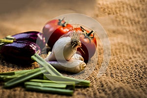 Close up of vegetables for a spicy Indian lunch i.e. Egg plant,Solanum melongena,Tomato,Solanum lycopersicum and spring onions,