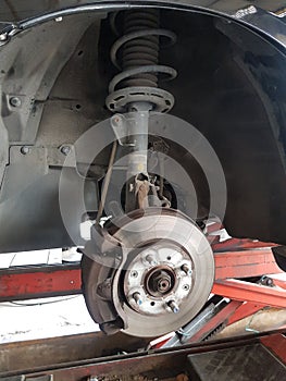 Close-up vehicle axle inspection, disc brake