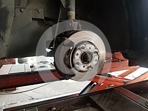 Close-up vehicle axle inspection, disc brake