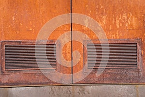 Close-up of ventilation in a rusty iron door